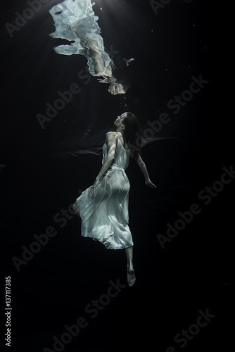 Young female ballet dancer dancing underwater