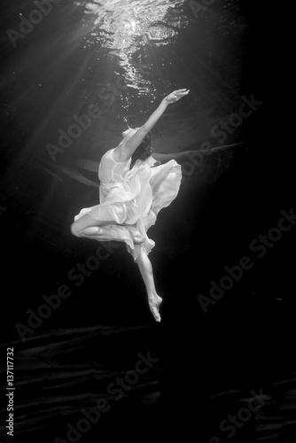 Young female ballet dancer dancing underwater