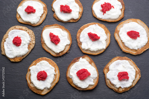Homemade blinis with sour cream and red caviar