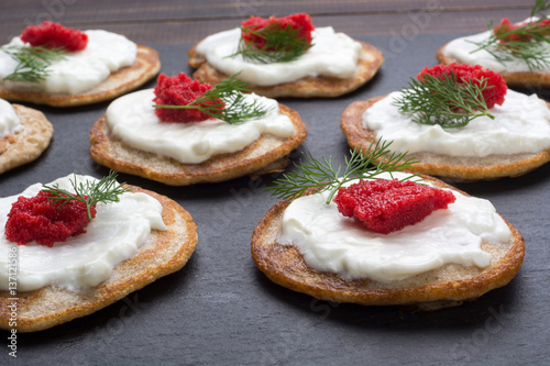 Homemade blinis with sour cream and red caviar