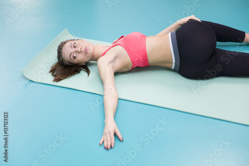 Young woman practicing pilates at the gym