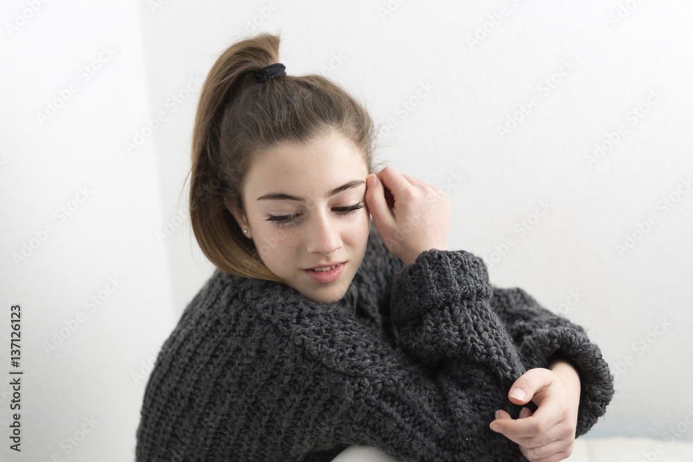 Young woman smelling on a white background. Horizontal shot with studio light. Young woman smelling on a white background. Horizontal shot with studio light.