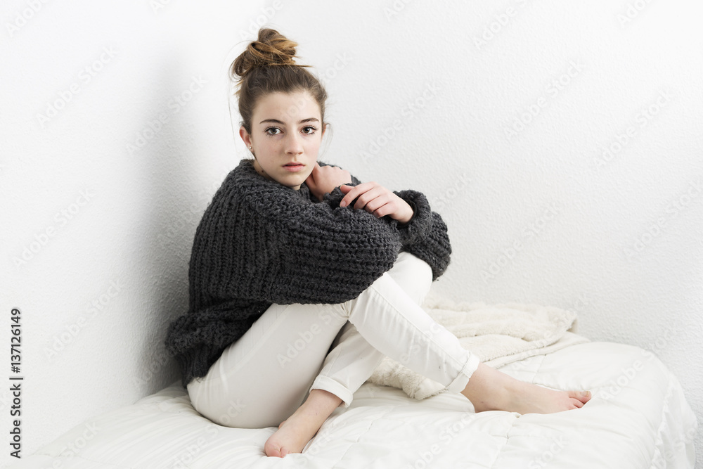 Fototapeta premium Young woman with serious face on a white background.