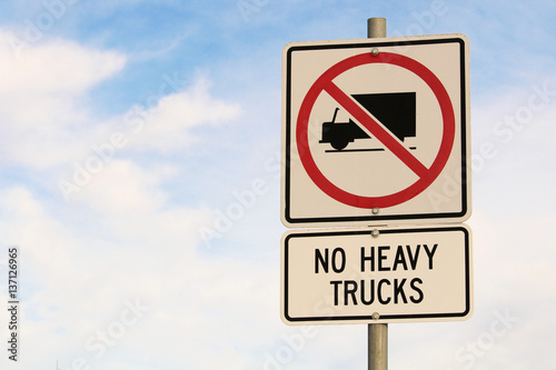 No Heavy Trucks Sign against Cloudy Blue Sky Background © Amelia
