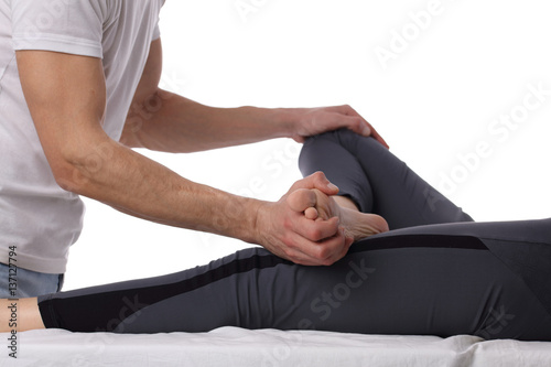 Chiropractic, osteopathy, dorsal manipulation. Therapist doing healing treatment on women's leg . Alternative medicine, pain relief concept isolated on white.