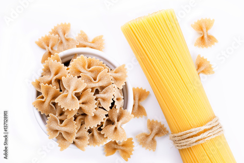 Organic Farfalle pasta and Spaghetti isolated on white