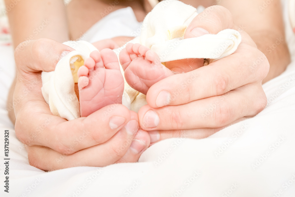 newborn baby in father's hands, indoor portrait