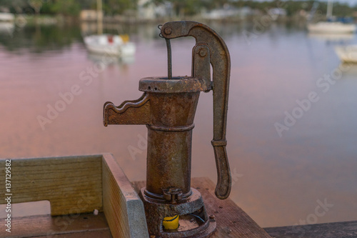 A Hand Pump Provides Water for Fishermen on a Pier