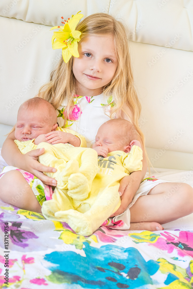 newborn baby and sister at home, indoor portrait