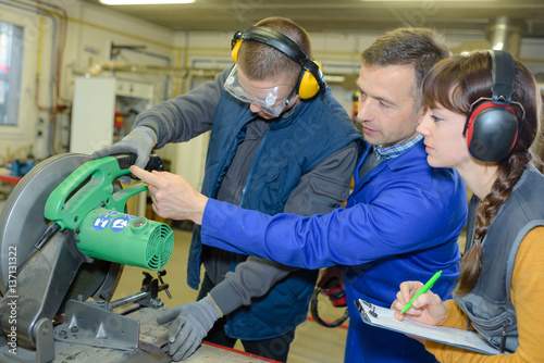 student in ironworks class using circular saw