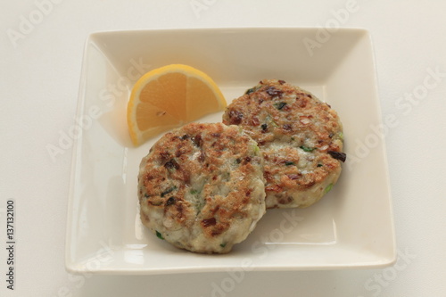 Homemade fish cake served with lemon photo