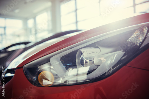 Headlights and hood of sport red car © standret
