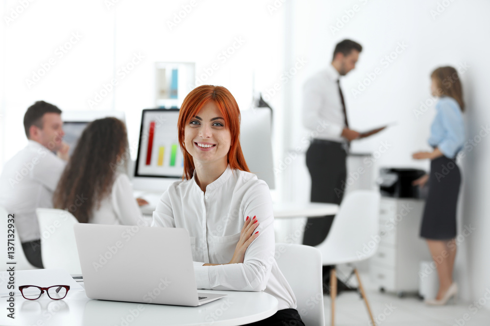 Woman working on computer at modern office