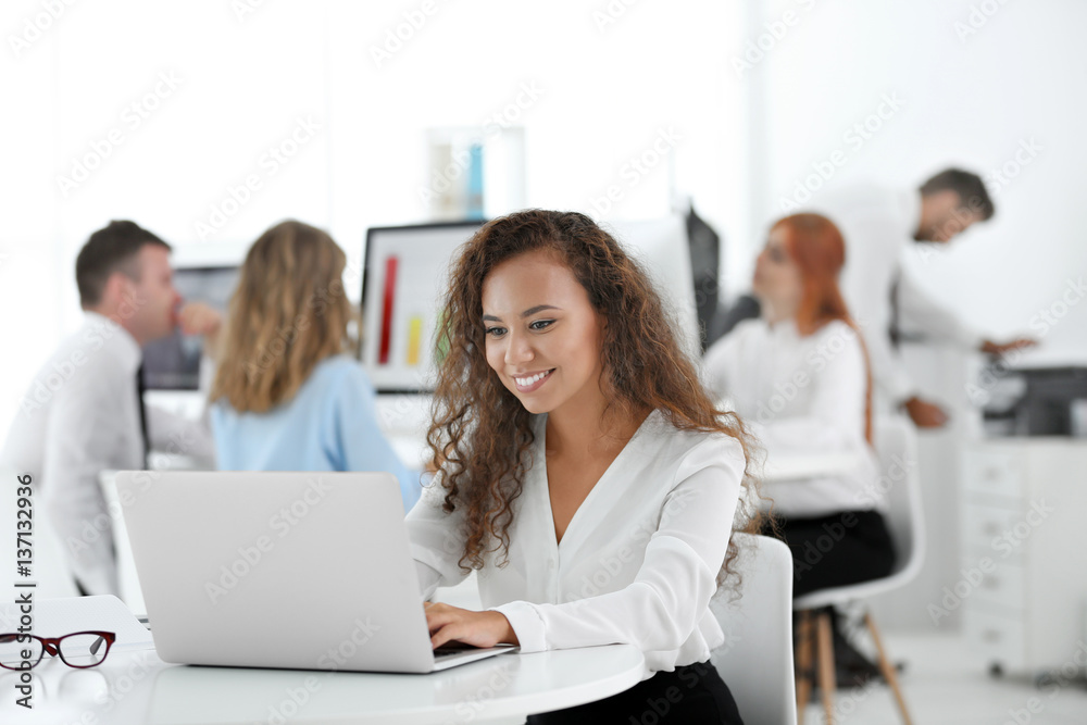 Woman working on computer at modern office