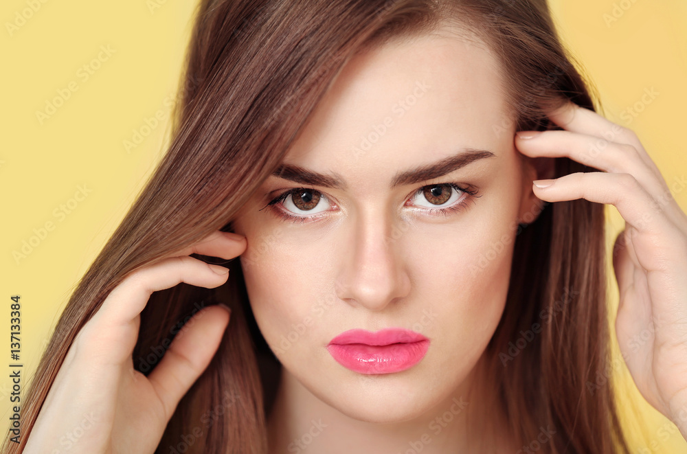 Naklejka premium Portrait of beautiful young woman on color background, close up