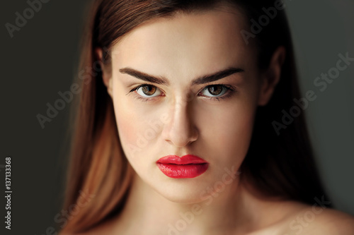 Portrait of beautiful young woman on color background  close up