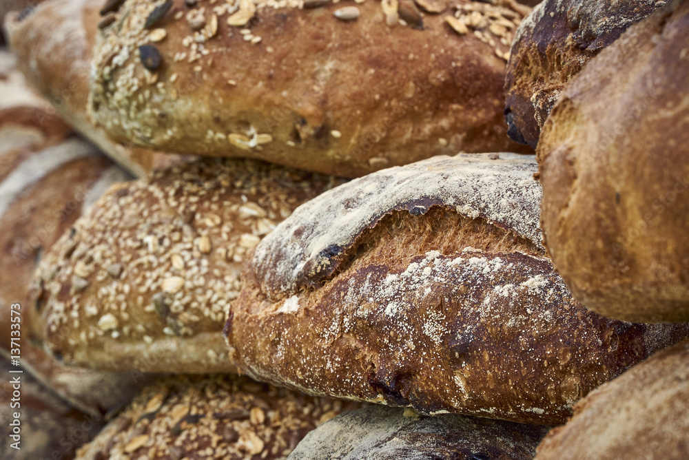 A stack of artisan seeded bread loaves - detail