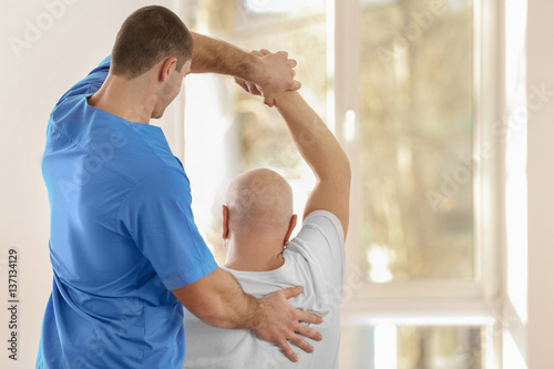Physiotherapist working wit...