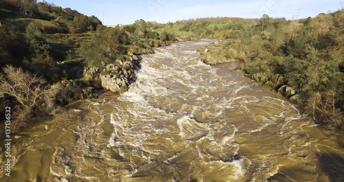 4k Aerial over raging river during the flood of 2017 in northern california. on the american river