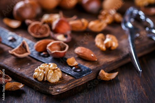 Nuts Mixed on Wooden Background.Assortment, Walnuts,Pecan,Peanuts,Almonds,Hazelnuts,Macadamia,Cashews,Pistachios.Concept of Healthy Eating.Vegetarian.selective focus.