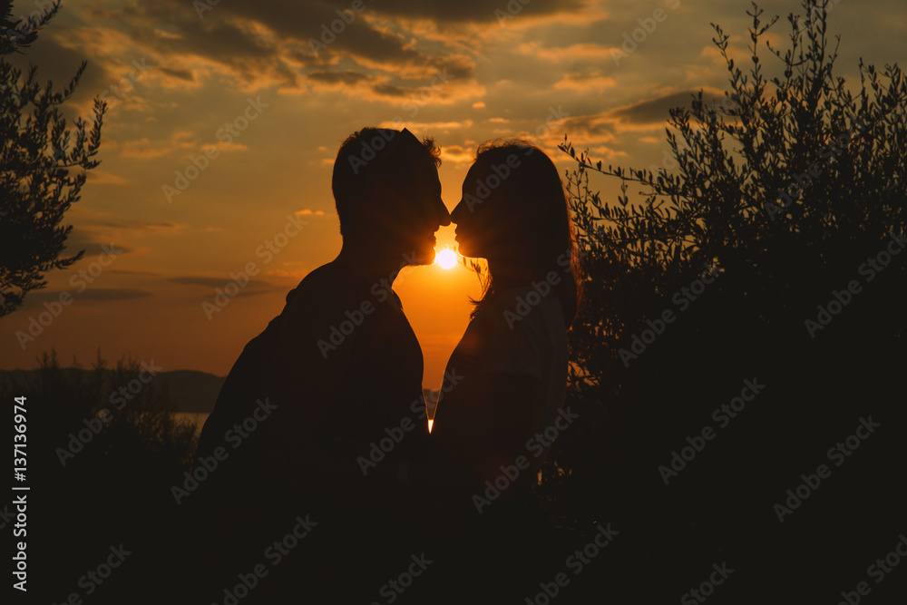 Сouple kissing on the sunset at the Garda Lake, Italy.