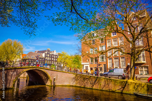 Traditional old buildings and boats in Amsterdam, Netherlands. Canals of Amsterdam.