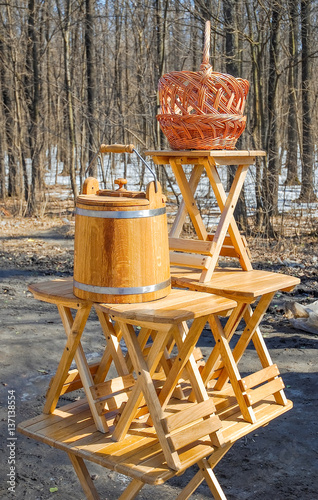 Trade of Handicrafts in the street in the spring. Woven baskets, rattan furniture and oak products for sauna photo