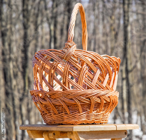 Trade of Handicrafts in the street in the spring. Wicker basket for mushrooms photo