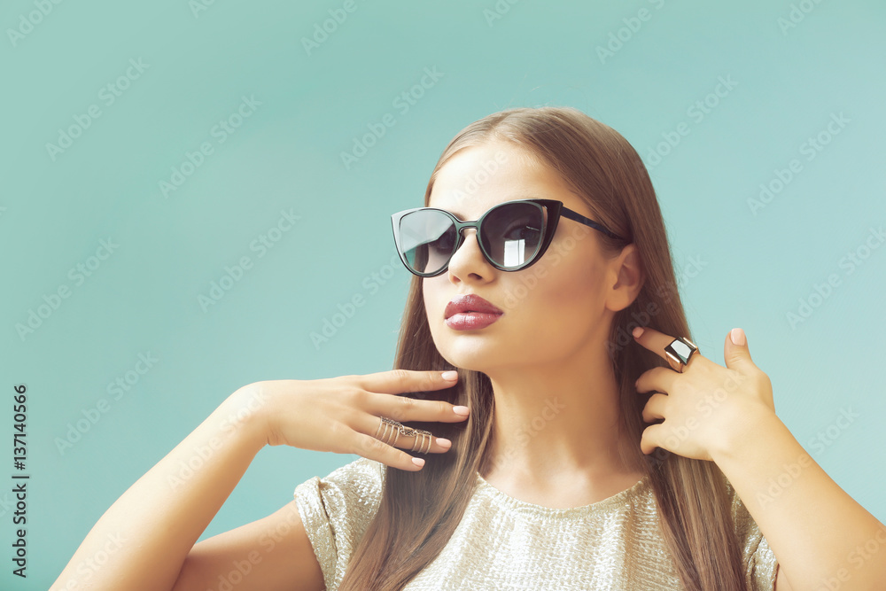 Portrait of beautiful young woman with sunglasses on colour background Portrait of beautiful young woman with sunglasses on colour background