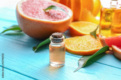 Aroma oil with citrus on color background