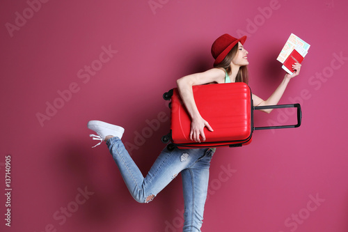 Woman traveler with suitcas...