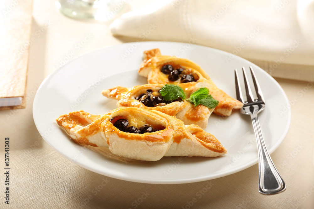 Tasty puff pastry with berries on plate