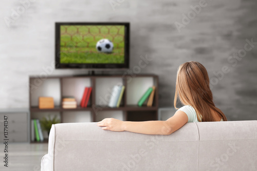 Pretty teenager watching TV...