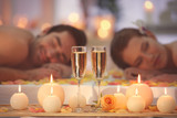 Beautiful spa composition with glasses and happy couple on background