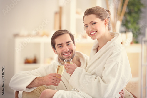 Young happy couple drinking...