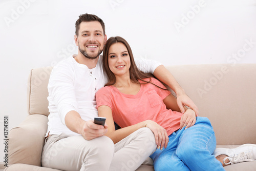 Young couple watching TV at home © Africa Studio