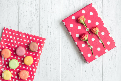 flowers and macaroon on wooden background top view pattern