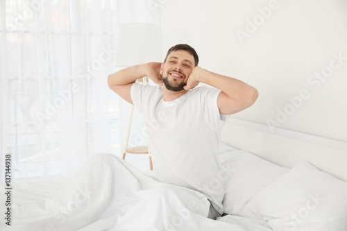 Young attractive man waking...