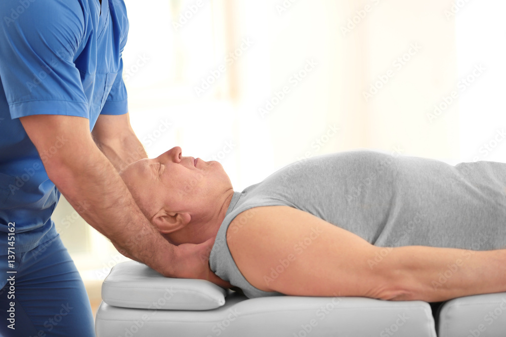 Physiotherapist working with elderly patient in clinic Physiotherapist working with elderly patient in clinic