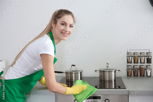 Young female worker of clea...