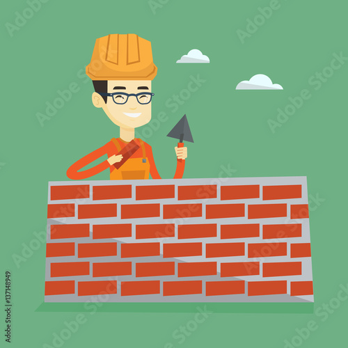 Bricklayer working with spatula and brick.