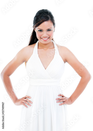 Young fashionable woman smiling with hands on hip