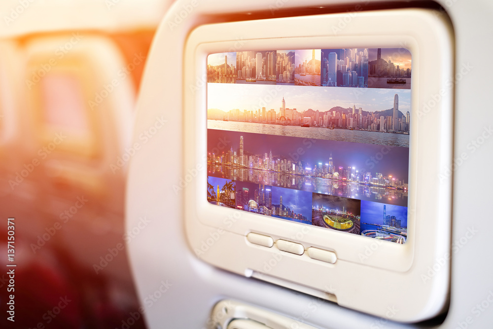 Aircraft monitor in front of passenger seat showing panoramic Victoria Harbour view, Hongkong Aircraft monitor in front of passenger seat showing panoramic Victoria Harbour view, Hongkong