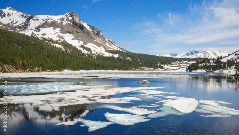 Timelapse of Melting Ice in Reflective Alpine Lake in Yosemite -Long Shot- Timelapse of Melting Ice in Reflective Alpine Lake in Yosemite -Long Shot-