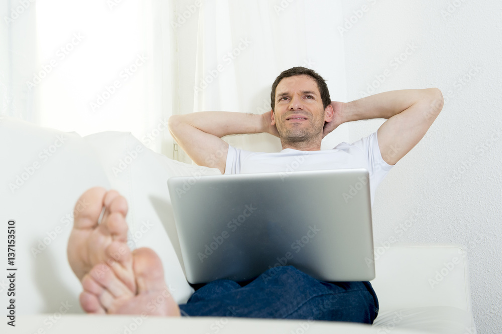 man freelancer working with computer laptop laying on couch at home relaxed daydreaming thinking man freelancer working with computer laptop laying on couch at home relaxed daydreaming thinking