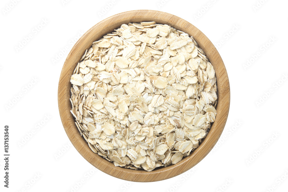 Oats in wooden bowl isolated top view on white Oats in wooden bowl isolated top view on white
