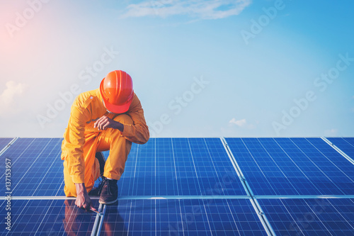 engineer working on checking and maintenance equipment at green energy solar power plant: Wrench tightening at solar mounting structure 