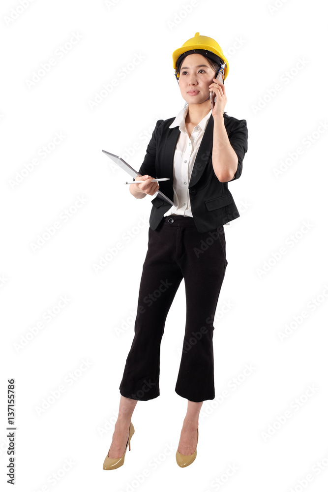 Young woman engineer holding digital tablet and using mobile phone isolated on white background Young woman engineer holding digital tablet and using mobile phone isolated on white background