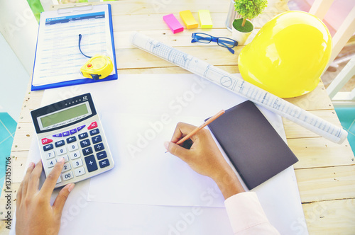 Wallpaper Mural Top view of A young Asian woman's hands that writing on notebook with Smartphone wooden table background,business stuff Torontodigital.ca