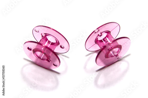 pink plastic bobbin for sewing machine